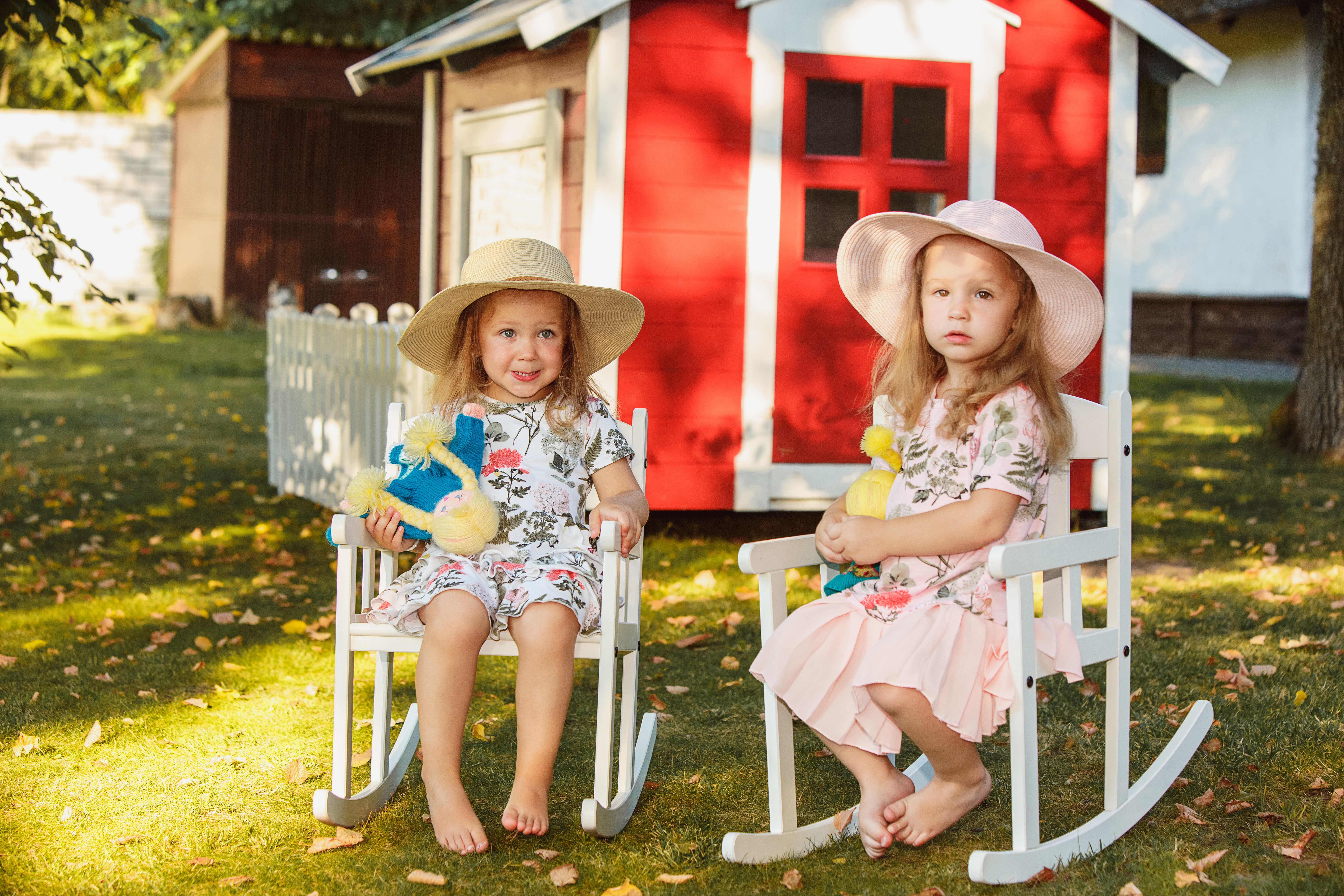 cute-little-blond-girls-hats-sitting-field-with-soft-toys-summer