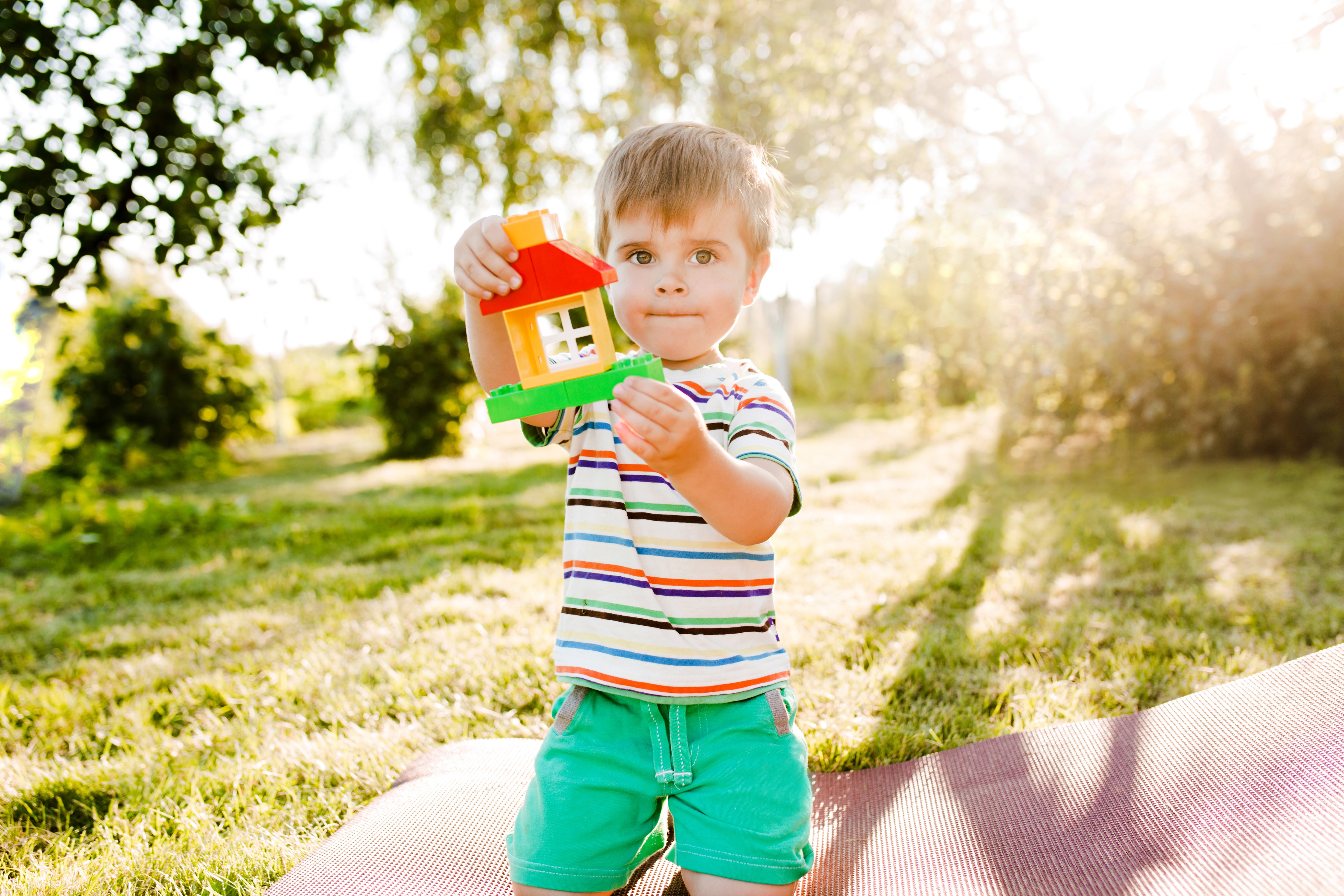 little-cute-boy-holding-toy-house-garden-looks-pensive