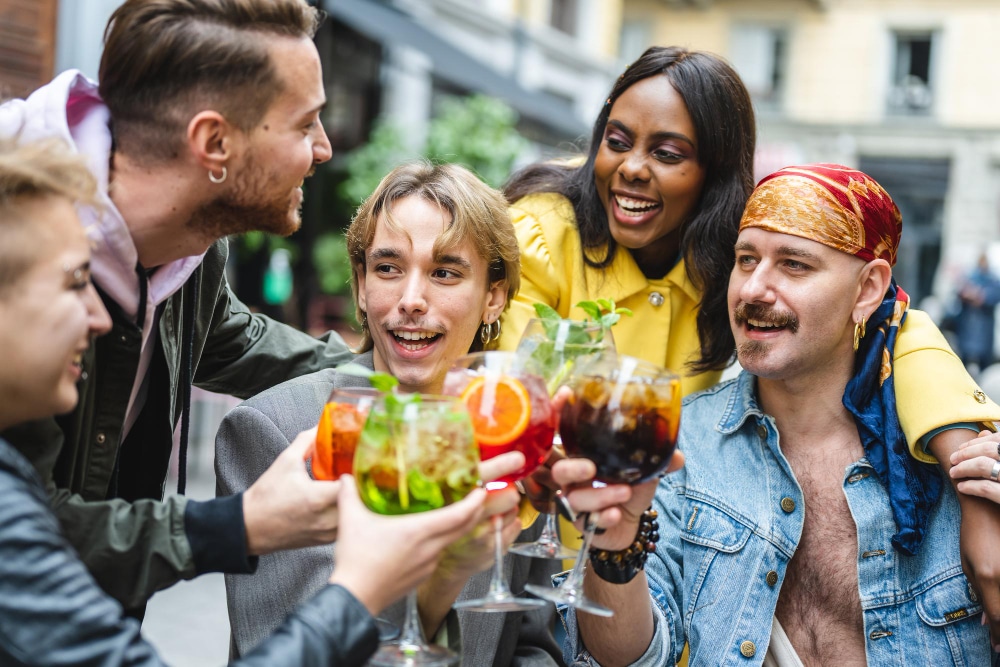 group-of-diverse-people-toasting-with-beverage-happy-friends-celebrating-and-drinking-cocktails-at-restaurant-lgbt-social-inclusion-concept